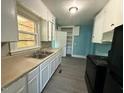 Kitchen features white cabinets, laminate countertops, and modern appliances at 1525 Hargrove St, Rocky Mount, NC 27801