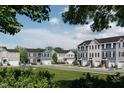 Inviting street view of new construction townhomes with well-manicured landscaping at 1537 Ivy Meadow Ln, Zebulon, NC 27597