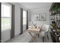 Well-lit home office featuring a modern desk, comfortable seating, and bookshelves for organization at 1541 Ivy Meadow Ln, Zebulon, NC 27597
