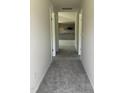 Hallway view leading into the spacious open-concept kitchen with modern appliances at 206 Coharie Dr, Lillington, NC 27546