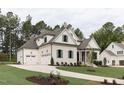 Beautifully landscaped yard showcasing a spacious three-car garage and manicured front lawn at 25 Alex Farm Ct, Zebulon, NC 27597