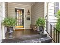 Inviting front porch with decorative plants, stylish lighting, and house number 2913 at 2913 Anderson Dr, Raleigh, NC 27608