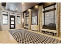 Elegant hallway featuring patterned carpeting, sconce lighting, and neutral paint at 317 W Morgan St # 320, Raleigh, NC 27601