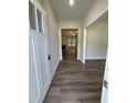 Bright entryway showcasing wood floors that lead into a living room with a fireplace at 322 Busterfield Ct, Benson, NC 27504