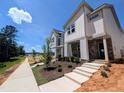 New home features modern design, manicured landscaping, and convenient sidewalk access in a desirable community at 330 Cottage Hill Way, Knightdale, NC 27604