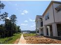 Attractive two-story home in new community against blue sky, with sidewalk leading to the property at 330 Cottage Hill Way, Knightdale, NC 27604
