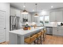 Well-appointed kitchen with stainless appliances, center island with seating, and ample cabinet space at 330 Cottage Hill Way, Knightdale, NC 27604