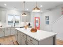 Bright, modern kitchen featuring a large island, pendant lighting and stainless appliances at 330 Cottage Hill Way, Knightdale, NC 27604
