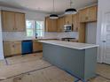 Bright kitchen features a spacious island, modern appliances, designer backsplash, and stylish light fixtures at 330 Cottage Hill Way, Knightdale, NC 27604