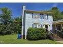 Charming two-story home featuring blue siding, blue shutters, and a brick chimney at 3510 Rawdon Dr, Durham, NC 27713