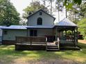 Back exterior of house with wood deck and gazebo at 358 Pool Rock Shores Ln, Henderson, NC 27537