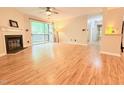 Open living room with a ceiling fan, fireplace, and sliding door to patio with exterior views at 4120 Sedgewood Dr # 106, Raleigh, NC 27612