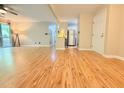 Open concept living room with wood flooring and an entrance doorway, with natural light at 4120 Sedgewood Dr # 106, Raleigh, NC 27612
