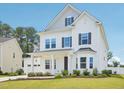 Charming two-story home with a well-manicured lawn and attached two car garage at 514 Bonville Ct, Fuquay Varina, NC 27526