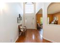 Bright foyer featuring hardwood floors, a front door, and a decorative bench at 5501 Southern Cross Ave, Raleigh, NC 27606