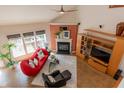 Bright and airy living room with a fireplace, vaulted ceiling, and large windows at 5501 Southern Cross Ave, Raleigh, NC 27606