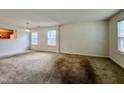 Spacious living room featuring two large windows and neutral-colored walls at 5911 Endsley Ct, Raleigh, NC 27610