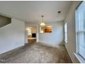 Inviting living room with plush carpeting, neutral walls, and lots of natural light at 5911 Endsley Ct, Raleigh, NC 27610