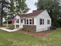 Well-maintained home with vinyl siding, brick accents, and a manicured front yard at 6300 Nc 27, Coats, NC 27521