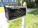 Close up of a mailbox with house number and street name against a blurred green backdrop at 8 Woodsprite Ct, Durham, NC 27703