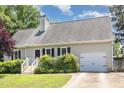 Inviting single-story home with garage, complemented by lush landscaping and a well-maintained lawn at 809 Maple Shade Ln, Apex, NC 27502