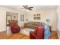 Open living room with hardwood floors, stylish furniture, and view into dining area at 809 Maple Shade Ln, Apex, NC 27502