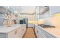 An open kitchen with an island, marble countertops and stainless steel appliances at 98102 Drummond, Chapel Hill, NC 27517