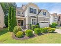 Two-story home with stone and siding exterior, a manicured lawn, and a two-car garage at 1008 Justice Walk Ave, Morrisville, NC 27560