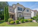 Charming two-story home with landscaped front yard and dark window shutters at 1008 Justice Walk Ave, Morrisville, NC 27560