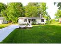 View of the house with a well-maintained lawn and a long driveway leading up to it at 10180 Buffalo Rd, Clayton, NC 27527