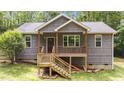 Charming exterior of the home with a quaint porch and gray shake siding at 1027 Holden Rd, Youngsville, NC 27596