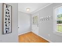 Bright entryway featuring hardwood floors, coat rack, and decorative wall art at 105 Choyce Ct, Garner, NC 27529