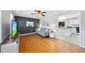 Cozy living room with hardwood floors, modern decor, and a glimpse of the kitchen at 105 Choyce Ct, Garner, NC 27529