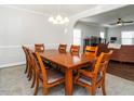 Bright dining room open to living room with large wooden table and seating for ten at 105 Pink Dogwood Ln, Mebane, NC 27302