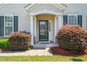 Inviting covered front porch with decorative columns and lush landscaping, creating a warm welcome at 107 Meeting Hall Dr, Morrisville, NC 27560