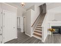 Bright hallway with hardwood floors, staircase, and access to multiple rooms, creating an open flow at 107 Meeting Hall Dr, Morrisville, NC 27560