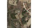 Aerial view of property showcasing land acreage, residence, pond, and proximity to neighborhood at 108 Cedarwood Dr, Louisburg, NC 27549