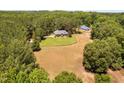 Aerial view of private residence with large yard and acreage in a wooded location at 108 Cedarwood Dr, Louisburg, NC 27549