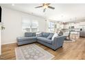 Cozy living room with plush sofa, wood floors, and open floor plan at 1101 Hazelmist Dr, Youngsville, NC 27596