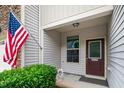 Inviting front entrance with a patriotic American flag and decorative foliage at 114 Constitution Dr, Durham, NC 27705