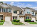 Townhome exterior features stone accents, attached garages, and well-maintained landscaping at 114 Constitution Dr, Durham, NC 27705