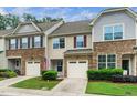 Townhome exterior features stone accents, attached garages, and well-maintained landscaping at 114 Constitution Dr, Durham, NC 27705