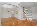 Spacious dining room showcases gleaming hardwood floors, decorative molding, and abundant natural light from the windows at 117 Arborhill Ln, Holly Springs, NC 27540