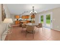 Open kitchen with center island, stainless appliances, and adjacent dining area with doors to the backyard at 118 Brandi Dr, Rolesville, NC 27571