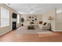 Spacious living room featuring a cozy fireplace, plush seating, and a ceiling fan for added comfort at 118 Brandi Dr, Rolesville, NC 27571