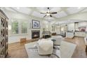Bright living room boasts a stone fireplace, coffered ceilings, and hardwood floors at 1211 New Grissom Way, Wake Forest, NC 27587