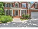 Inviting front entrance with brick steps, black shutters, and tasteful landscaping enhancing curb appeal at 123 W Camden Forest Dr, Cary, NC 27518