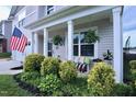 Cozy front porch with decorative plants and comfortable seating, perfect for relaxing outdoors at 1254 Salters St, Burlington, NC 27215