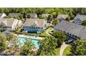 Aerial view of townhouses with a community pool surrounded by lush greenery at 1313 Legacy Greene Ave, Wake Forest, NC 27587