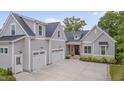 Attractive craftsman-style home with three-car garage, grey siding and a dark shingle roof at 14 Duck Bill Trl, Pittsboro, NC 27312